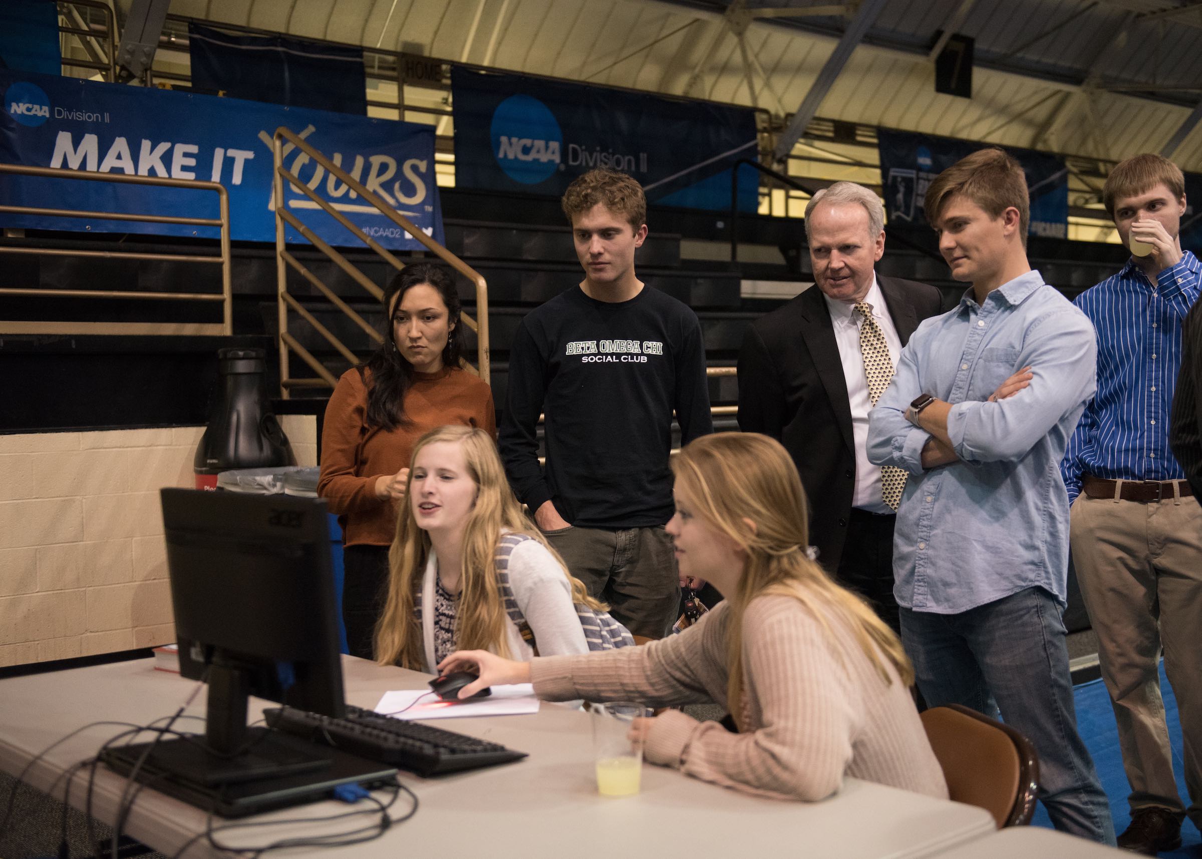 Several students and Harding President Bruce McLarty view the space race game
